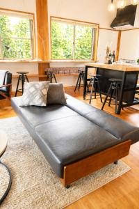 a black bed in a living room with a table at 源泉かけ流し温泉貸切別荘 霧島のテラス in Kirishima