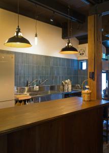 a large kitchen with a large wooden counter top at ISEZI Private Estate in Shibata
