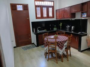 a kitchen with a table with chairs and a sink at The Grand Villa Malabe in Malabe