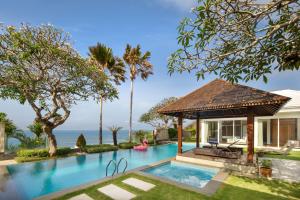 a pool with a gazebo next to a house at Pandawa Cliff Ocean view with private beach in Nusa Dua