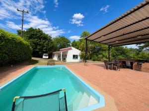 a swimming pool in a yard with a patio at Finca El Balmoral in Tocaima