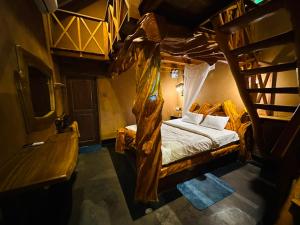 a bedroom with a bunk bed with a ladder at Ama Eco Lodge in Sigiriya