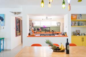 a kitchen with a table with a bowl of fruit at Casa Mila in La Paz