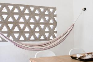 a hammock hanging on a wall in a dining room at Casa Mila in La Paz +22 photos