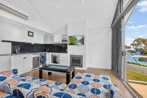 a living room with a couch and a table at Lufra Beachside Hotel in Eaglehawk Neck