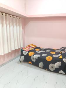 a bedroom with a bed with a colorful comforter at Swami's Yatri nivas in Akalkot +35 photos