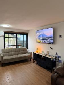 a living room with a couch and a flat screen tv at Las Minervas in Monterrey