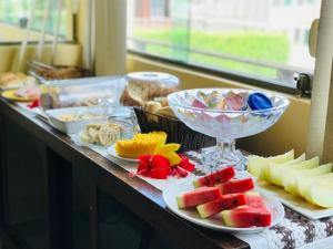 a table topped with plates of different types of food at Quarto privativo Pousada Luna in Fernando de Noronha +8 photos