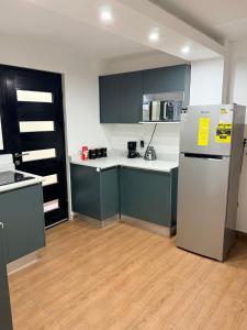 a kitchen with blue cabinets and a refrigerator at Las Minervas in Monterrey