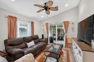 a living room with a couch and a flat screen tv at Abi's House - Private Jupiter Escape in Jupiter +30 photos