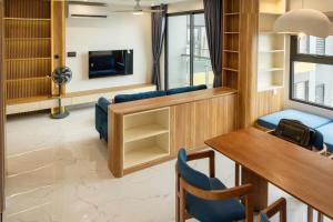 a living room with a table and chairs and a tv at Aquar Grand Park in Gò Công