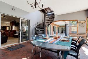 a dining room with a table and chairs at Palm View in Ballito