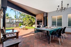 a patio with a green table and chairs at Palm View in Ballito