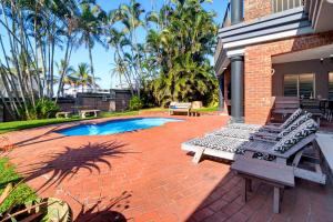 a patio with two chairs and a swimming pool at Palm View in Ballito