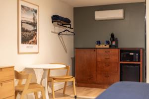 a room with a table and a kitchen with a microwave at The Iceberg Tahoe in South Lake Tahoe