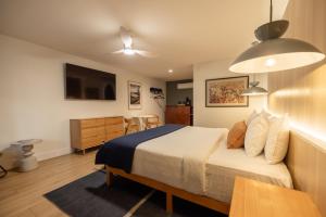 a bedroom with a bed and a tv and a table at The Iceberg Tahoe in South Lake Tahoe
