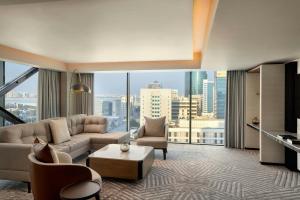a living room with a couch and a table at Sheraton Bahrain Hotel in Manama