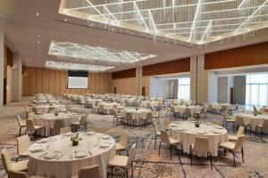 a large banquet hall with tables and chairs at Sheraton Bahrain Hotel in Manama +125 photos