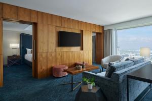 a hotel room with a couch and a tv at JW Marriott Austin in Austin