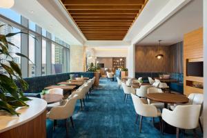 a restaurant with tables and chairs and windows at JW Marriott Austin in Austin