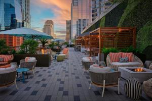 a patio with chairs and tables and a fire pit at JW Marriott Austin in Austin