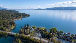 an aerial view of a lake with trees and houses at The Cottages at Bigfork in Bigfork