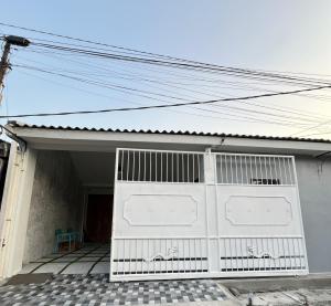 a white garage door on a house at Kuraya Urban Space in Surabaya