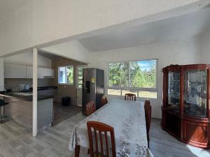 a kitchen with a table and chairs and a kitchen with a counter at Finca El Balmoral in Tocaima