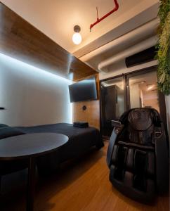 a room with a bed and a table and a chair at Nap York Central Park Sleep Station in New York