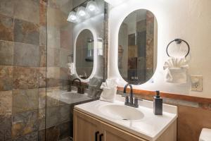 a bathroom with a sink and two mirrors at The Iceberg Tahoe in South Lake Tahoe +39 photos