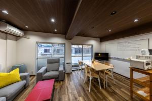 a living room with a couch and a table at Kame Ame House in Kameoka