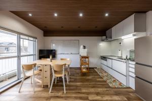 a kitchen and dining room with a table and chairs at Kame Ame House in Kameoka
