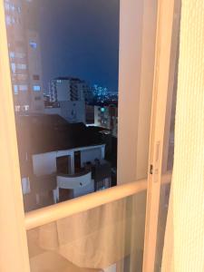 a view of a city at night from a window at Sky Luxury Suites in Bucaramanga