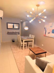 a living room with a table and a couch at Sky Luxury Suites in Bucaramanga