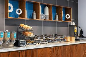 a kitchen with a counter with bread and other foods at SpringHill Suites by Marriott Dayton Vandalia in Murlin Heights