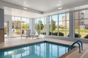 a swimming pool in a house with windows at SpringHill Suites by Marriott Dayton Vandalia in Murlin Heights