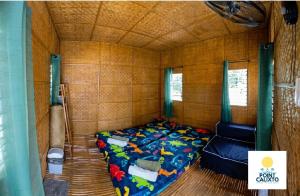 a bedroom with a bed in a small room at Point Calixto beach front hut, Boracay in Boracay