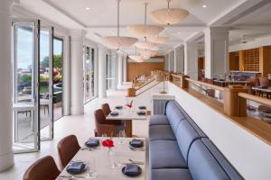 a restaurant with a blue couch and tables and chairs at OUTRIGGER Kaua'i Beach Resort & Spa in Lihue