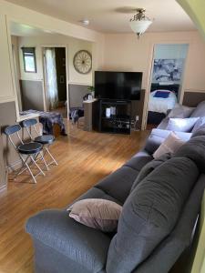 a living room with a couch and a bed at maison chez René in Saint-Malachie