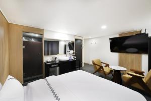 a hotel room with a bed and a kitchen at 서천 마리 호텔 in Seocheon