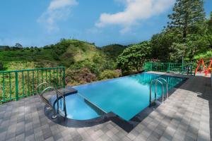 a swimming pool with a mountain in the background at Falcon Crest in Vagamon