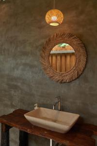 a bathroom with a sink and a mirror at The Woods Beachfront Tent Yao Noi in Ko Yao Noi
