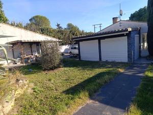 a house with a garage next to a driveway at Cité château de Carcassonne in Berriac