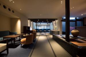 a lobby with tables and chairs in a building at Sowaka in Kyoto