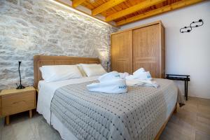 a bedroom with a bed with white pillows on it at The 2D Stay in Theológos
