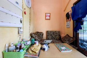 a room with a table and chairs in a room at Homestay E Rahayu Anyer RedPartner in Serang +13 photos