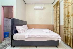 a bedroom with a bed in a room at Homestay E Rahayu Anyer RedPartner in Serang
