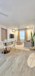 a large living room with a table and chairs at Nala Host - Maafushi Homes in Maafushi