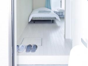 a pair of shoes in a room with a bed at ホテルステイ伊万里 in Imari +21 photos