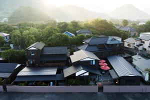 an aerial view of a house with black roofs at いっぺ The Sake Ryokan in Kyonan